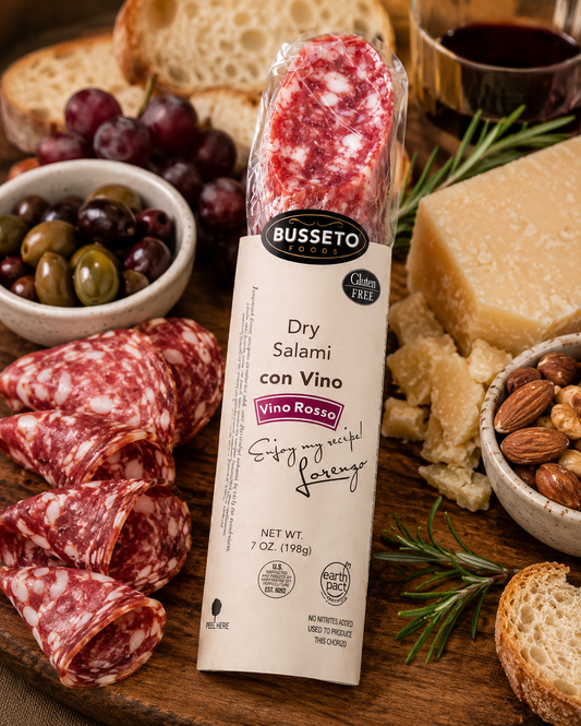 Busseto Red Wine Dry Salami paired with cheese olives crackers and breadsticks on a charcuterie board