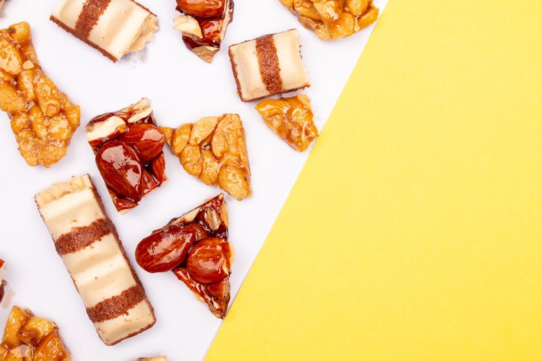 Assortment of sweet snack bars and nut brittle pieces.