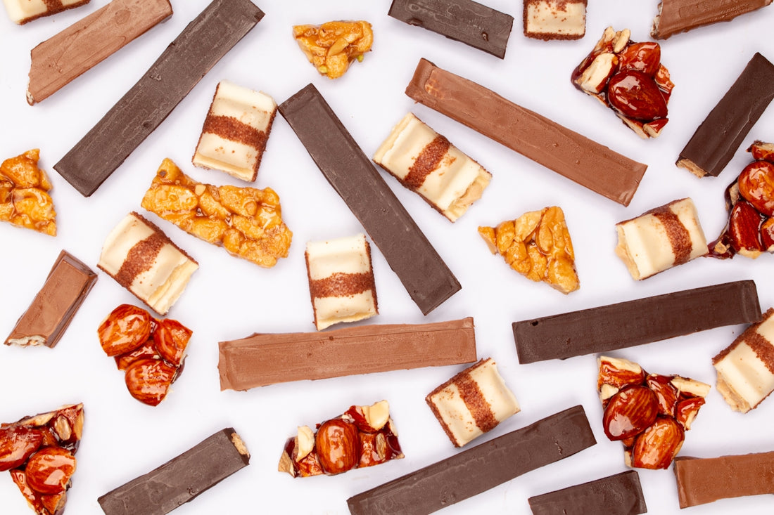 Assortment of chocolate bars and candy pieces.