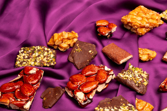 Assortment of nut and chocolate confections on purple fabric