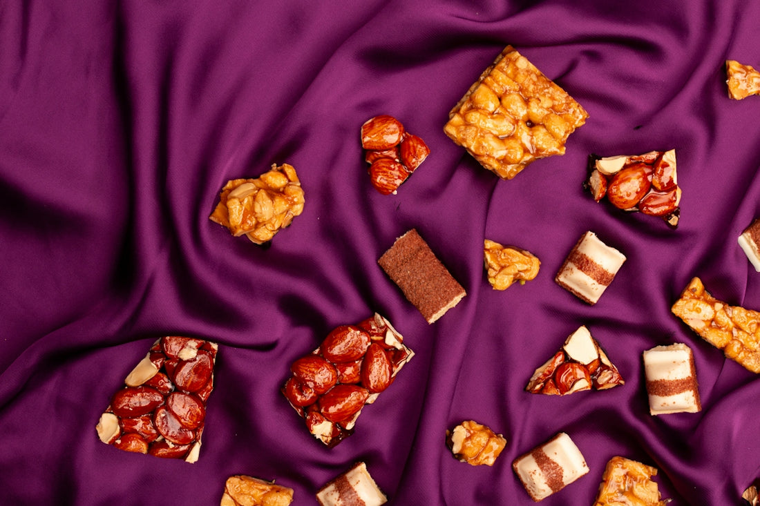 Assorted sweets and candies arranged on purple satin fabric