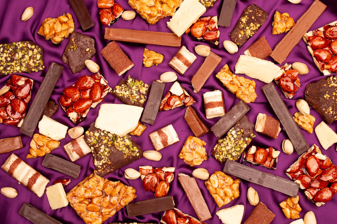 Assortment of chocolates and nuts on purple fabric