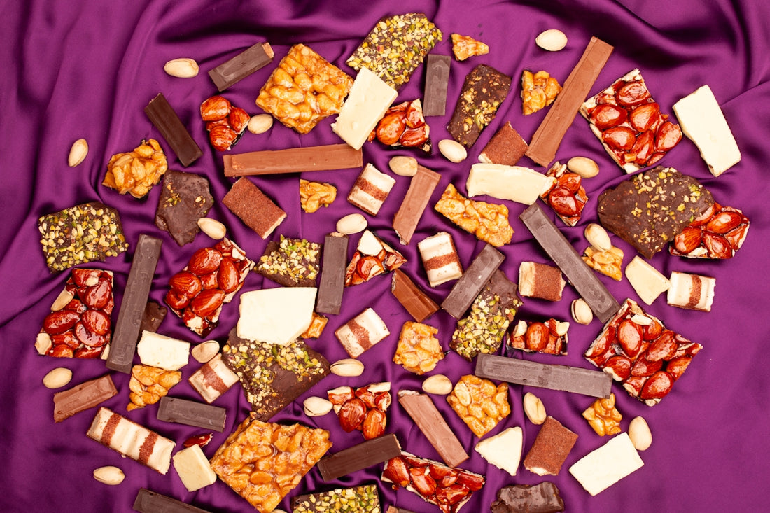 Assortment of chocolates and nuts on purple satin