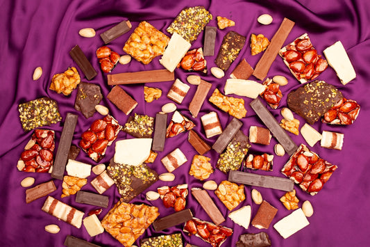 Assortment of chocolates and nuts on purple satin