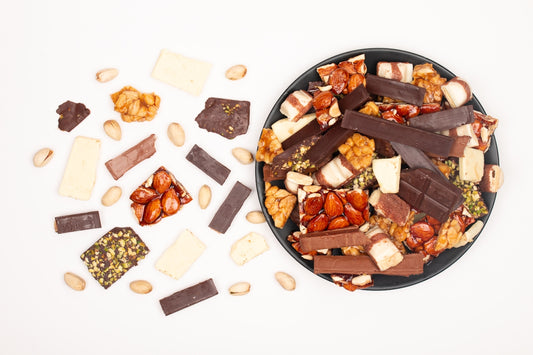 Assorted chocolate bars and nuts on a plate.