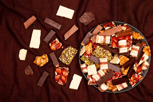 Assortment of chocolate bars and candies on a dark cloth