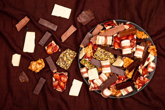 Assortment of chocolate bars and confectionery on a dark cloth