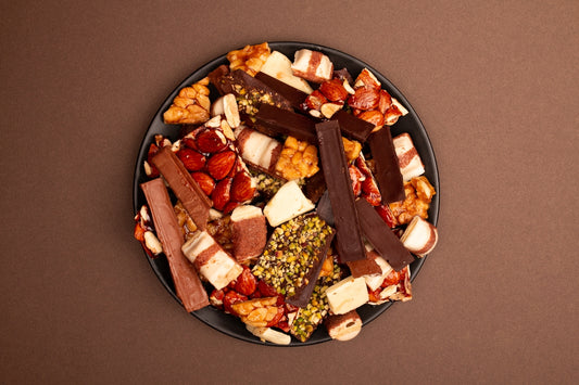 A plate full of assorted chocolate bars and sweets.