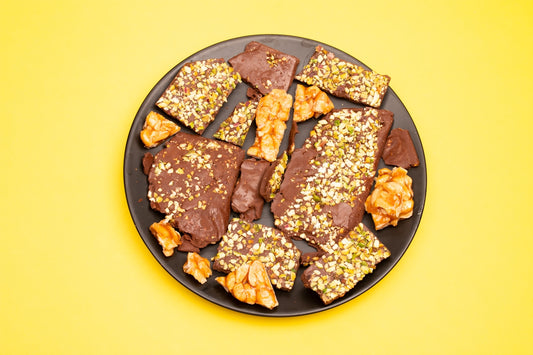 Assortment of chocolate bark with nuts on a plate