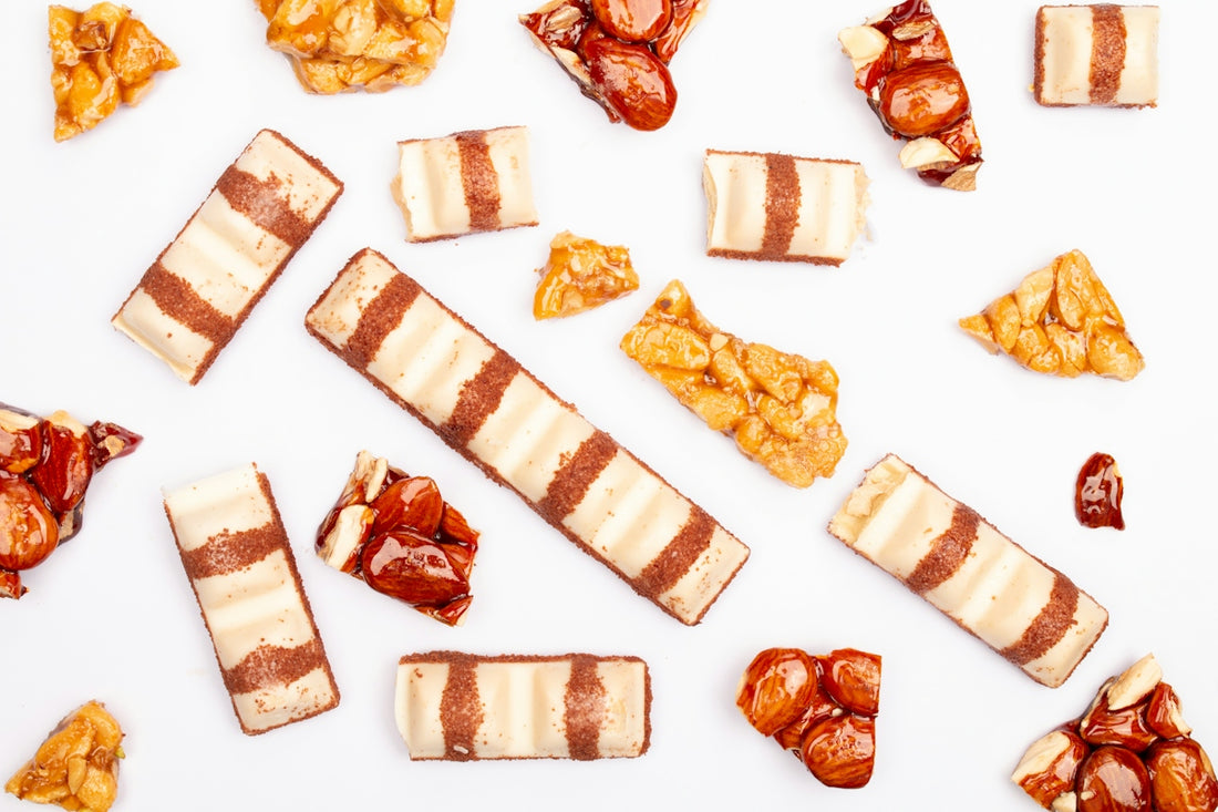 Assorted candies and nougat pieces on white background